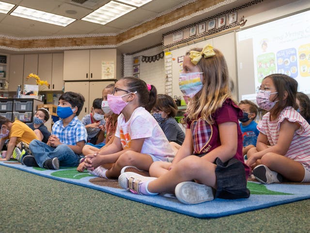 <p>Students listen to their teacher during their first day of transitional kindergarten at Tustin Ranch Elementary School in Tustin, California on 12 August 2021</p>