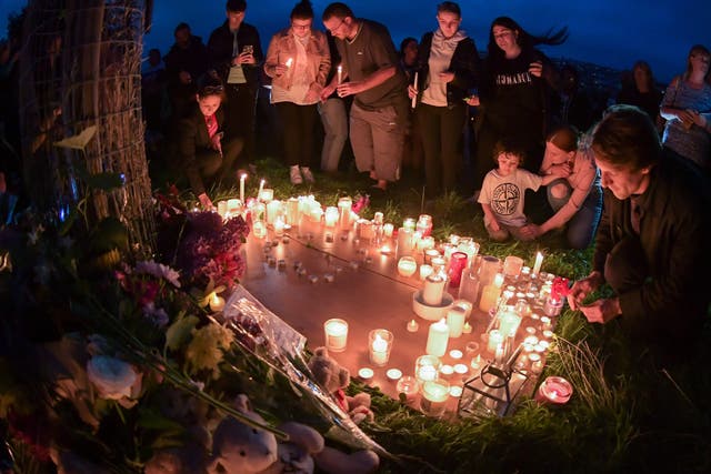 <p>People bowed their heads and held out candles in a moment on reflection in memory of the victims </p>