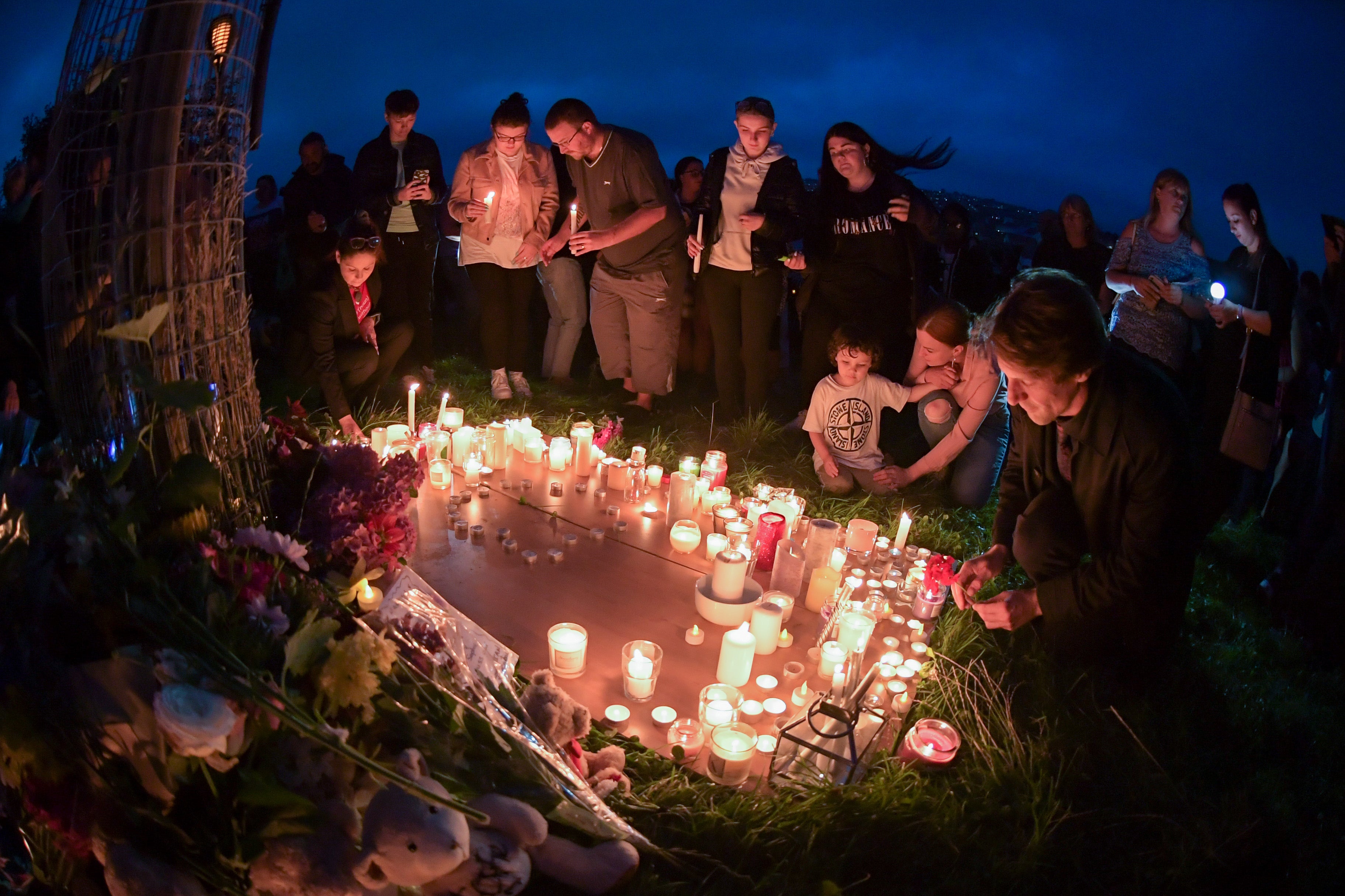 <p>A candlelit vigil is held at North Down Crescent Park, Plymouth, on Friday for victims of the shooting </p>