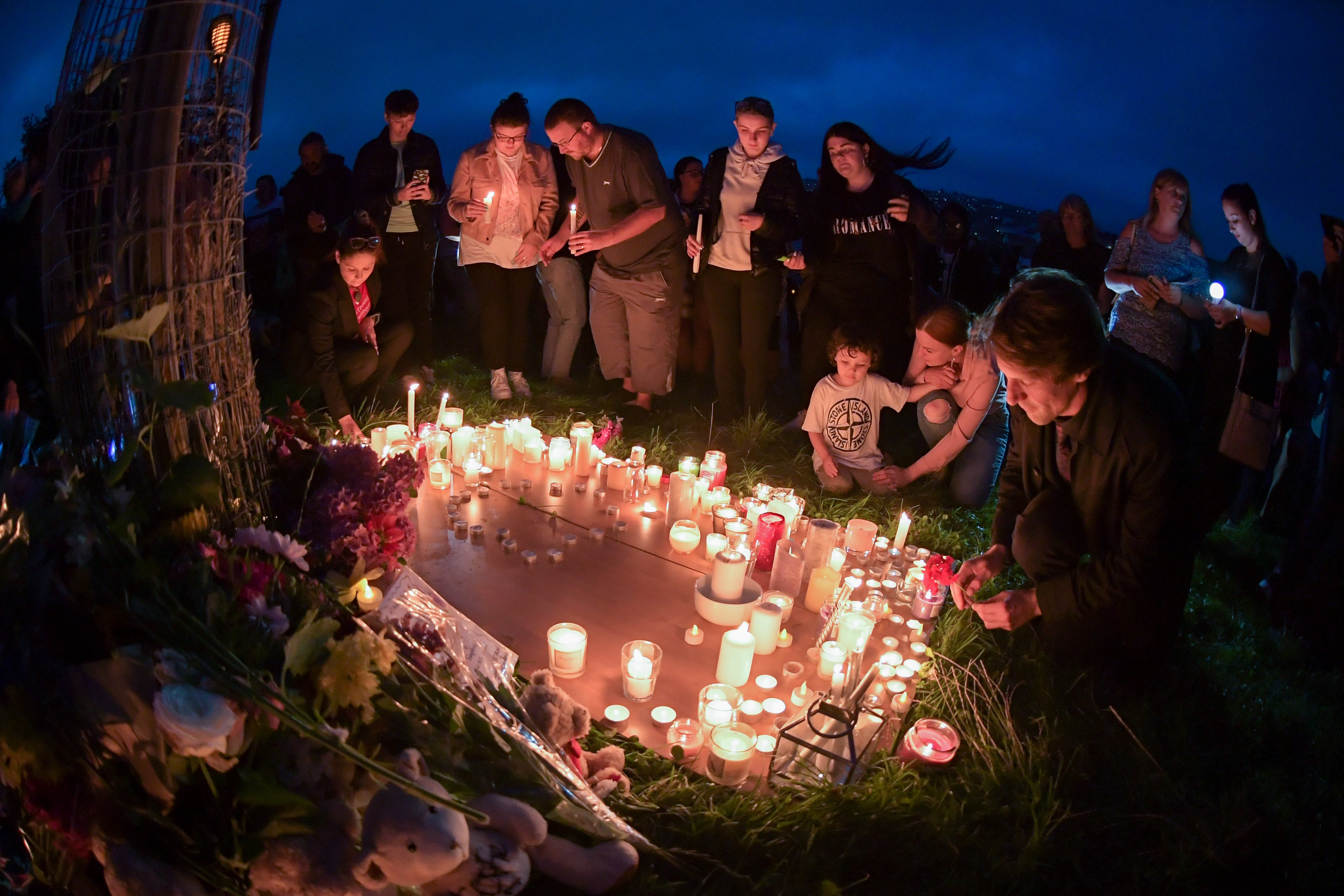 A candlelit vigil is held at North Down Crescent Park, Plymouth, on Friday for victims of the shooting