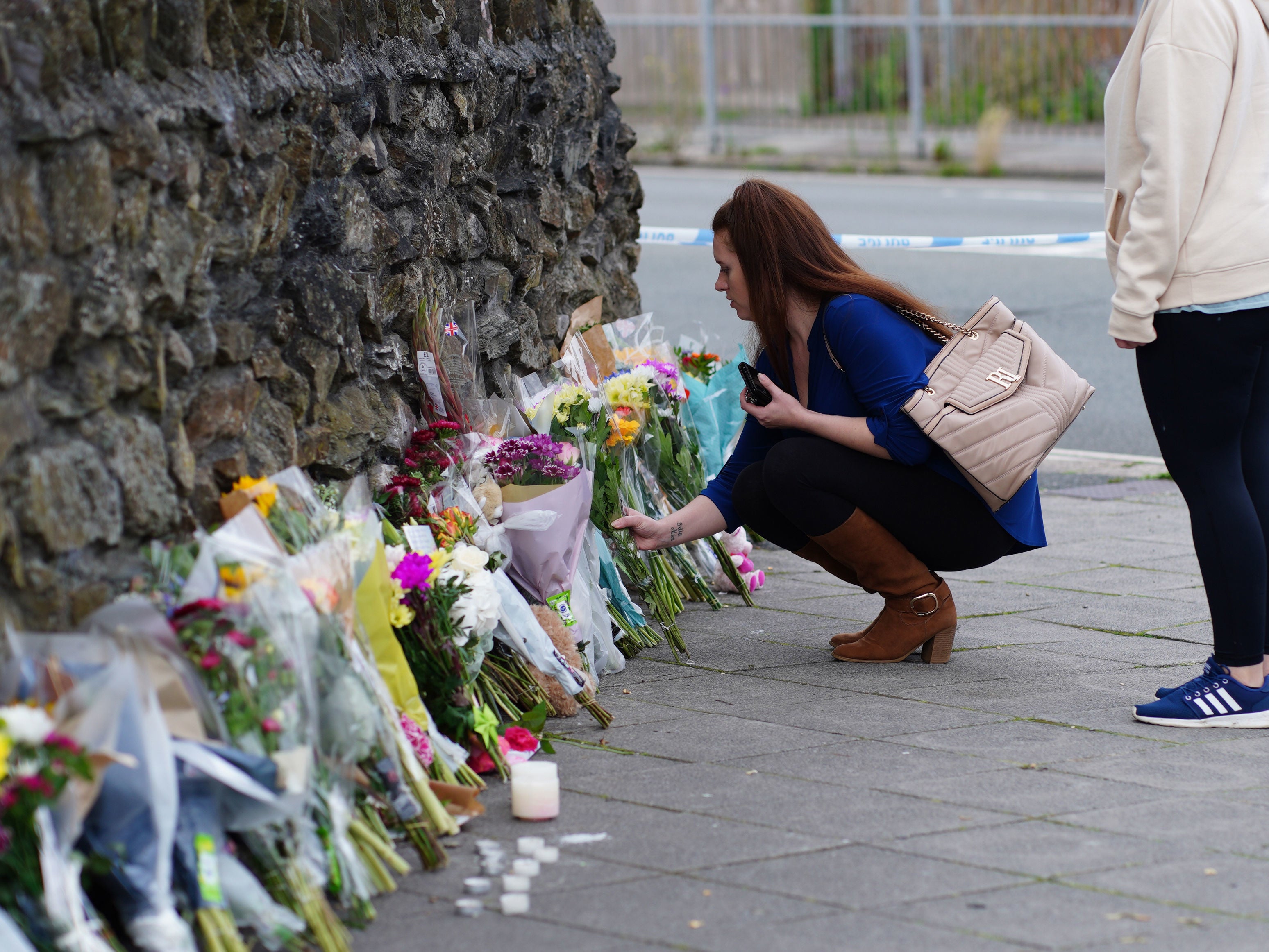 People leave flowers in the Keyham area of Plymouth where six people, including the offender, died of gunshot wounds