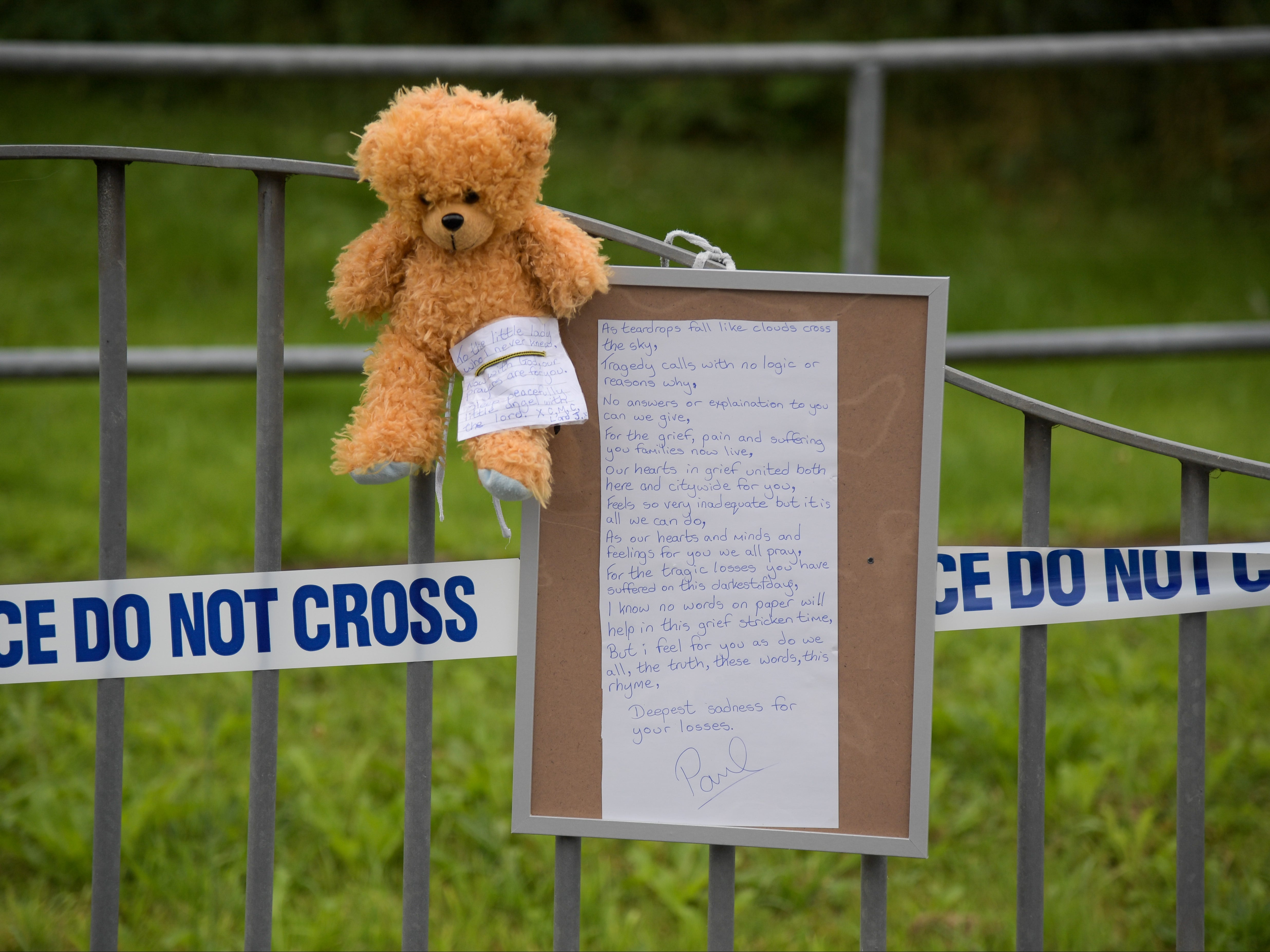 A teddy bear and message are seen at Biddick Drive