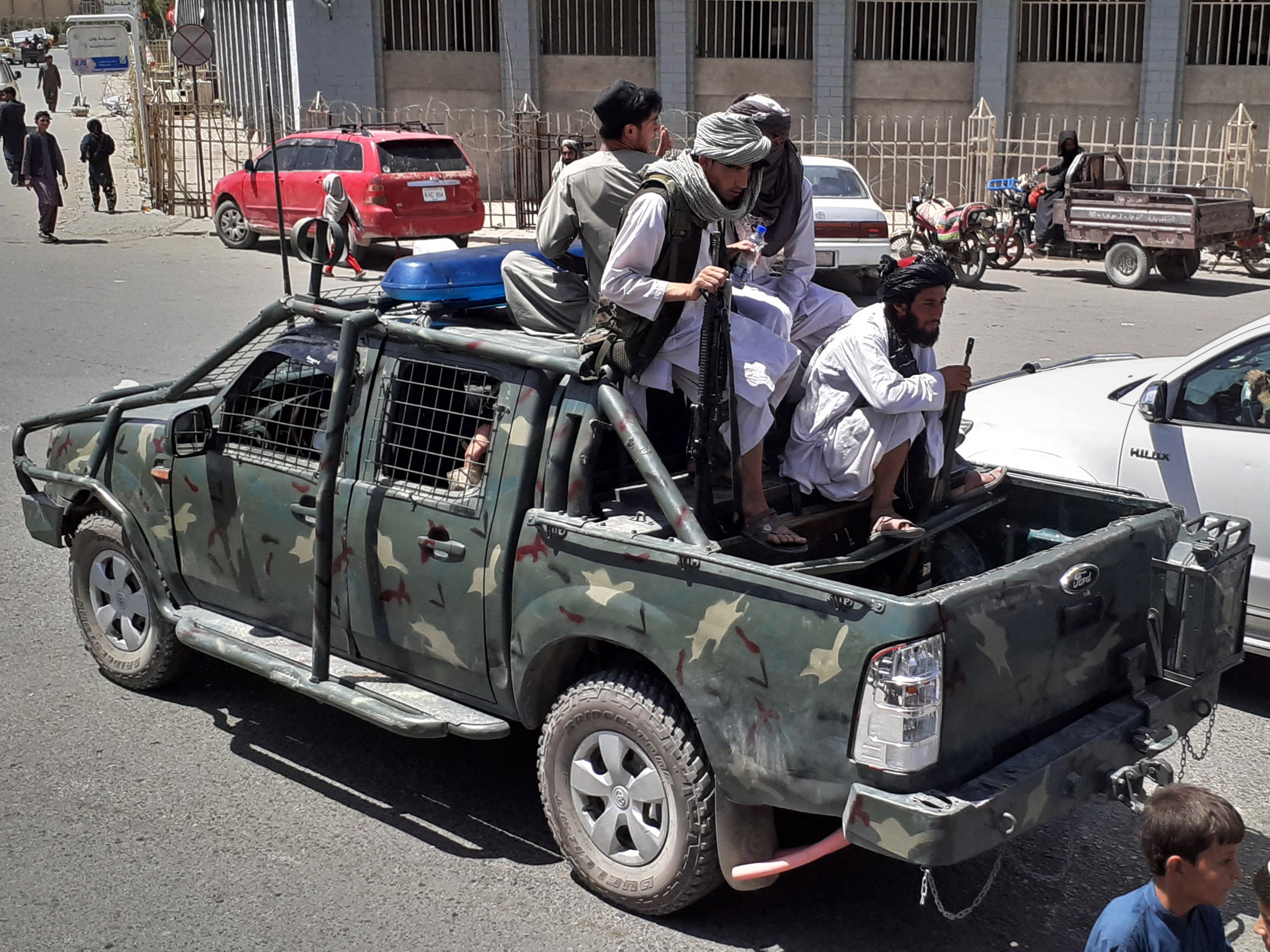 <p>Taliban fighters are pictured in a vehicle of Afghan National Directorate of Security (NDS) on a street in Kandahar on August 13, 2021</p>