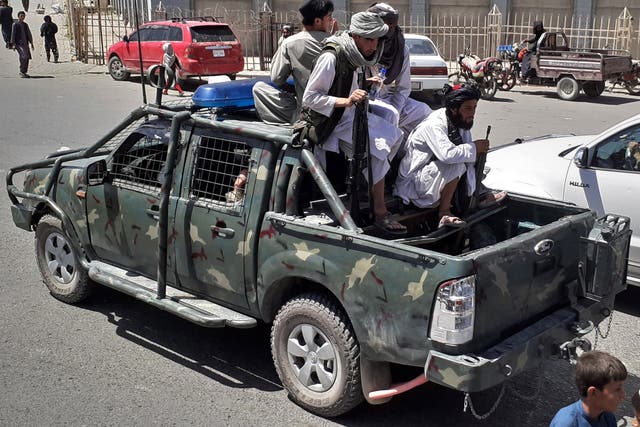 <p>Taliban fighters are pictured in a vehicle of Afghan National Directorate of Security (NDS) on a street in Kandahar on August 13, 2021</p>