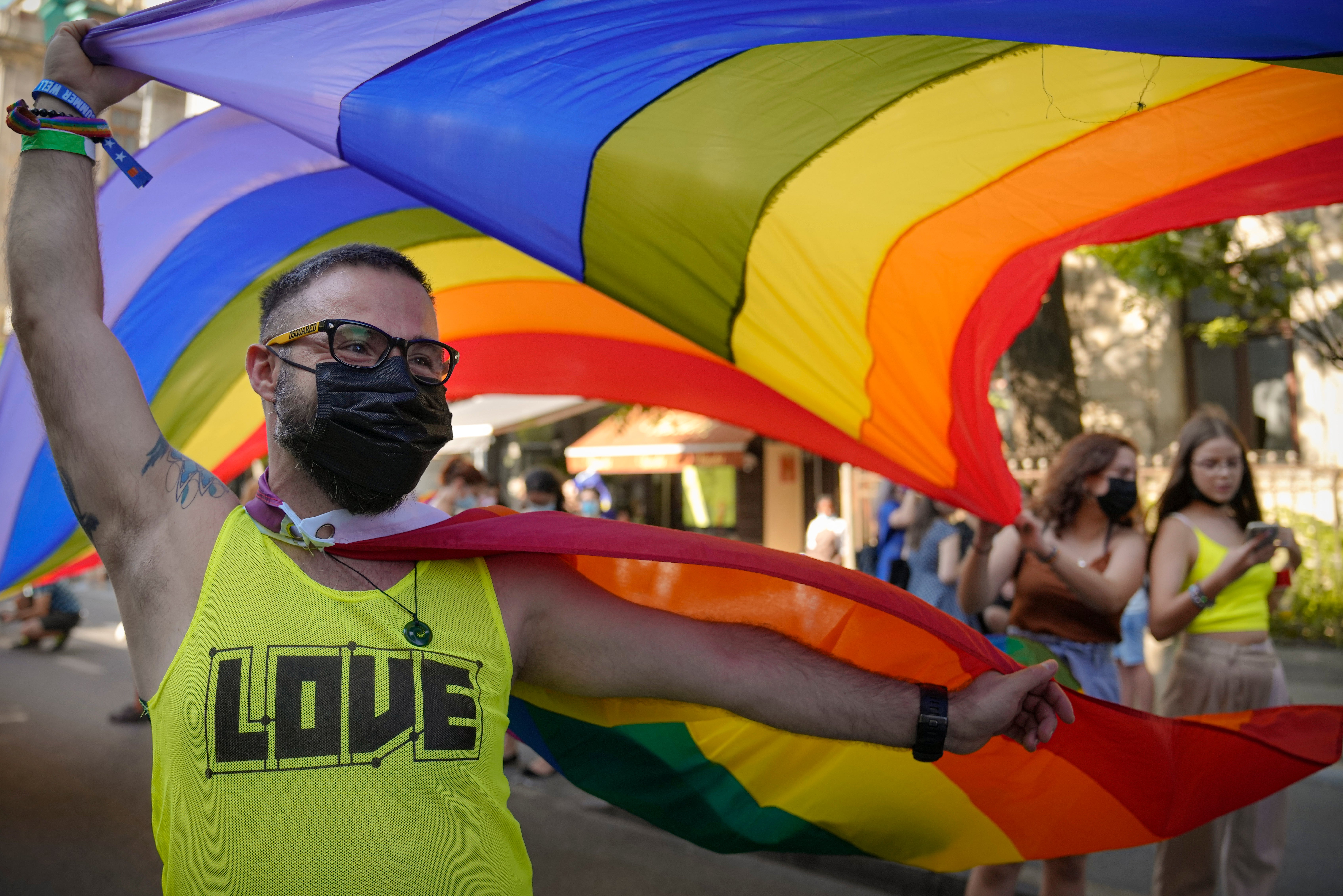 A participant waves the rainbow flag during the gay pride march in Bucharest, Romania