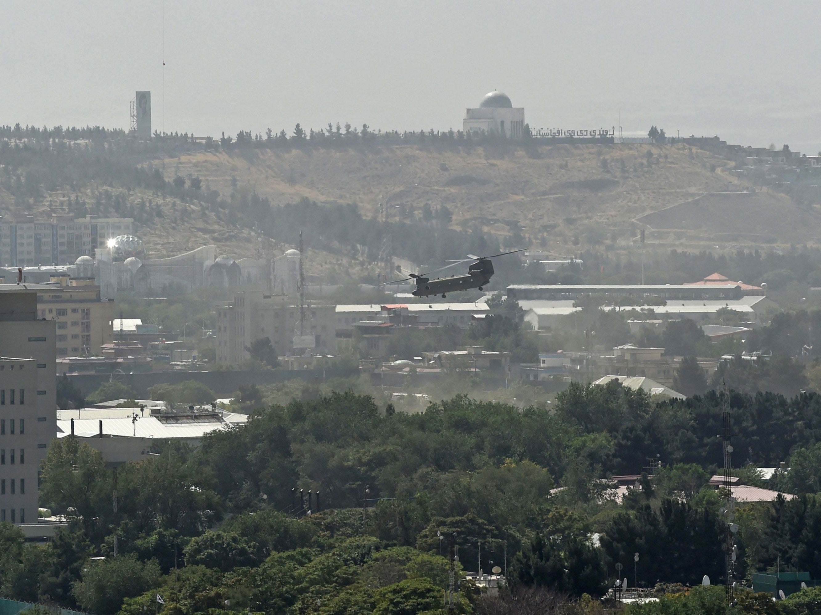 A US military helicopter is pictured flying above of US embassy in Kabul on the day the Taliban entered the capital