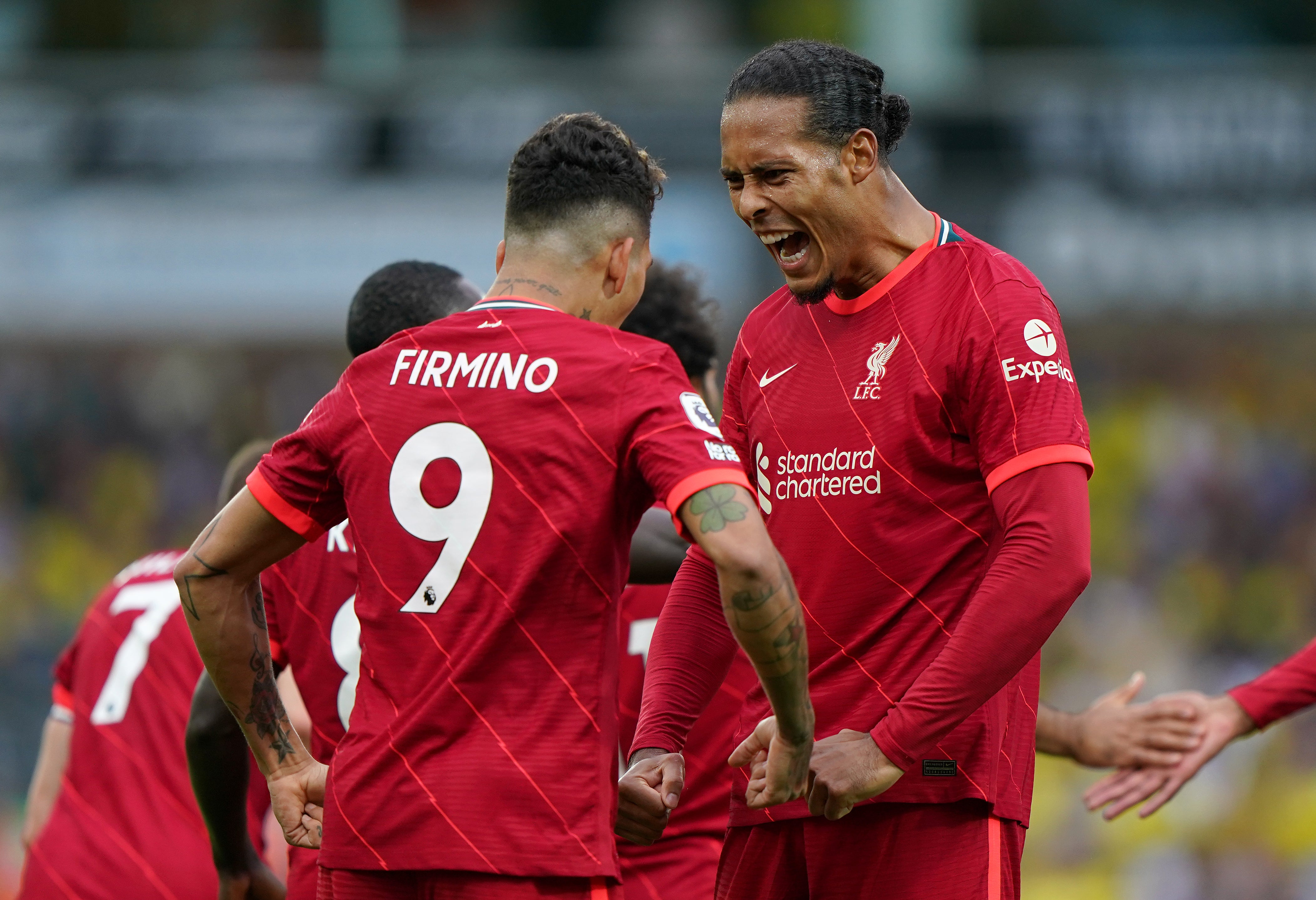 Virgil Van Dijk celebrates with Roberto Firmino during Liverpool’s 3-0 win over Norwich (Joe Giddens/PA)