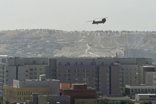 <p>A US military helicopter is pictured flying above the US embassy in Kabul </p>