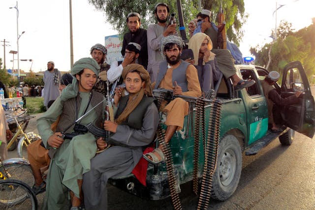 <p>Taliban fighters on patrol inside the city of Kandahar </p>