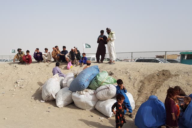 <p>A family with their belongings wait to cross the Friendship Gate crossing point at the Pakistan-Afghanistan border town of Chaman</p>