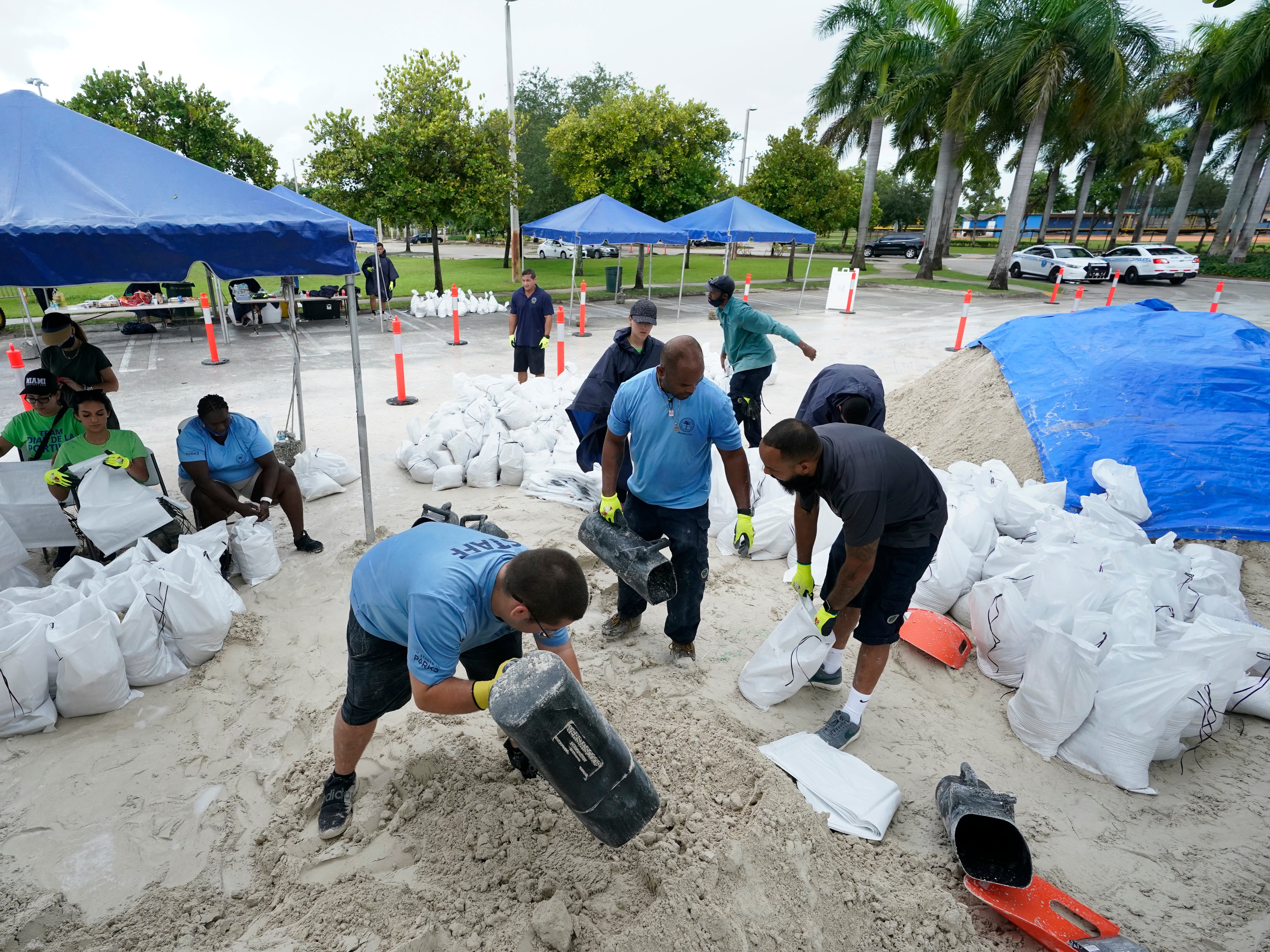 City workers fill sandbags at a drive-thru sandbag distribution event for residents ahead of the arrival of rains associated with tropical depression Fred, Friday, Aug. 13, 2021