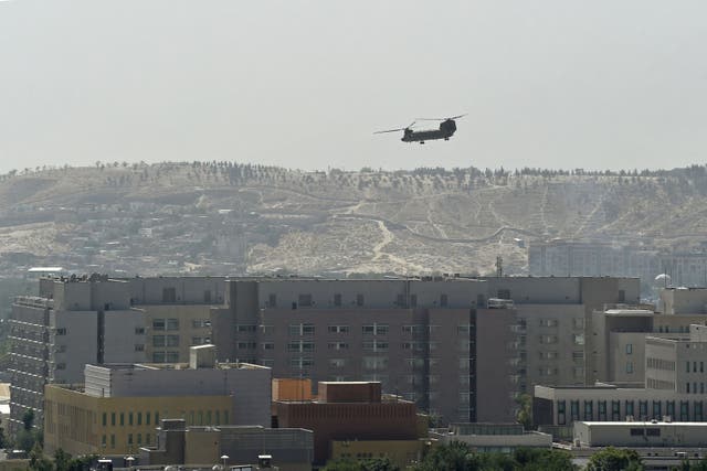 <p>A US military helicopter is pictured flying above of US embassy in Kabul, while the current scenes of evacuation from Afghanistan are  compared to Saigon in 1975 </p>