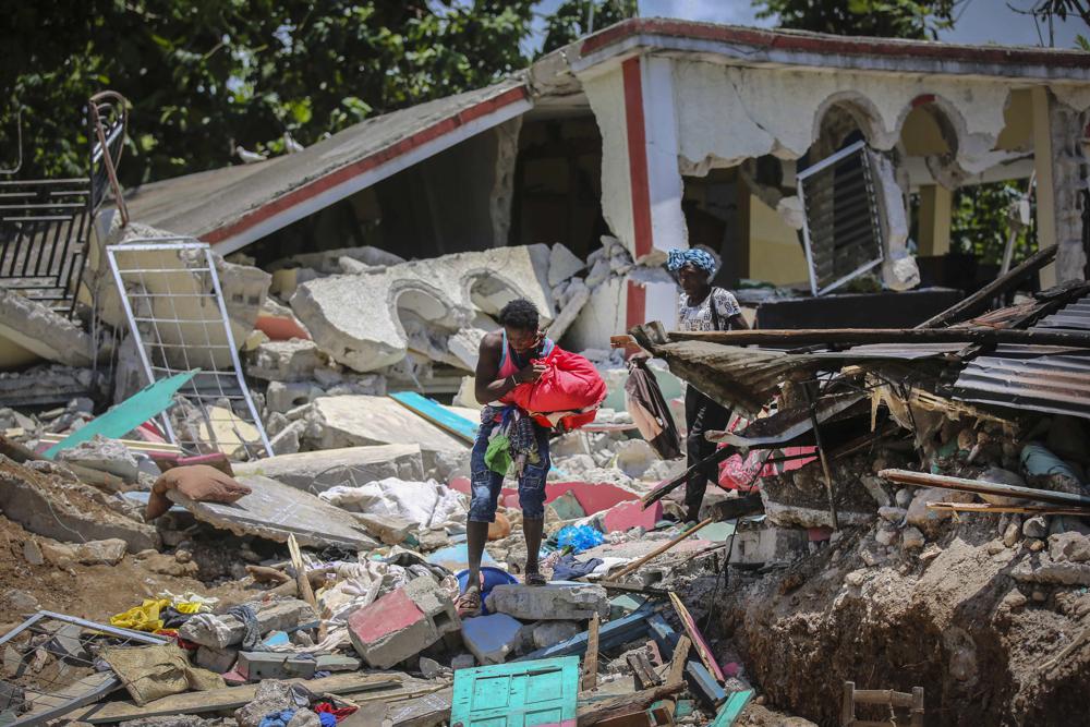 Locals recover their belongings from their homes destroyed in the earthquake in Camp-Perrin, Les Cayes