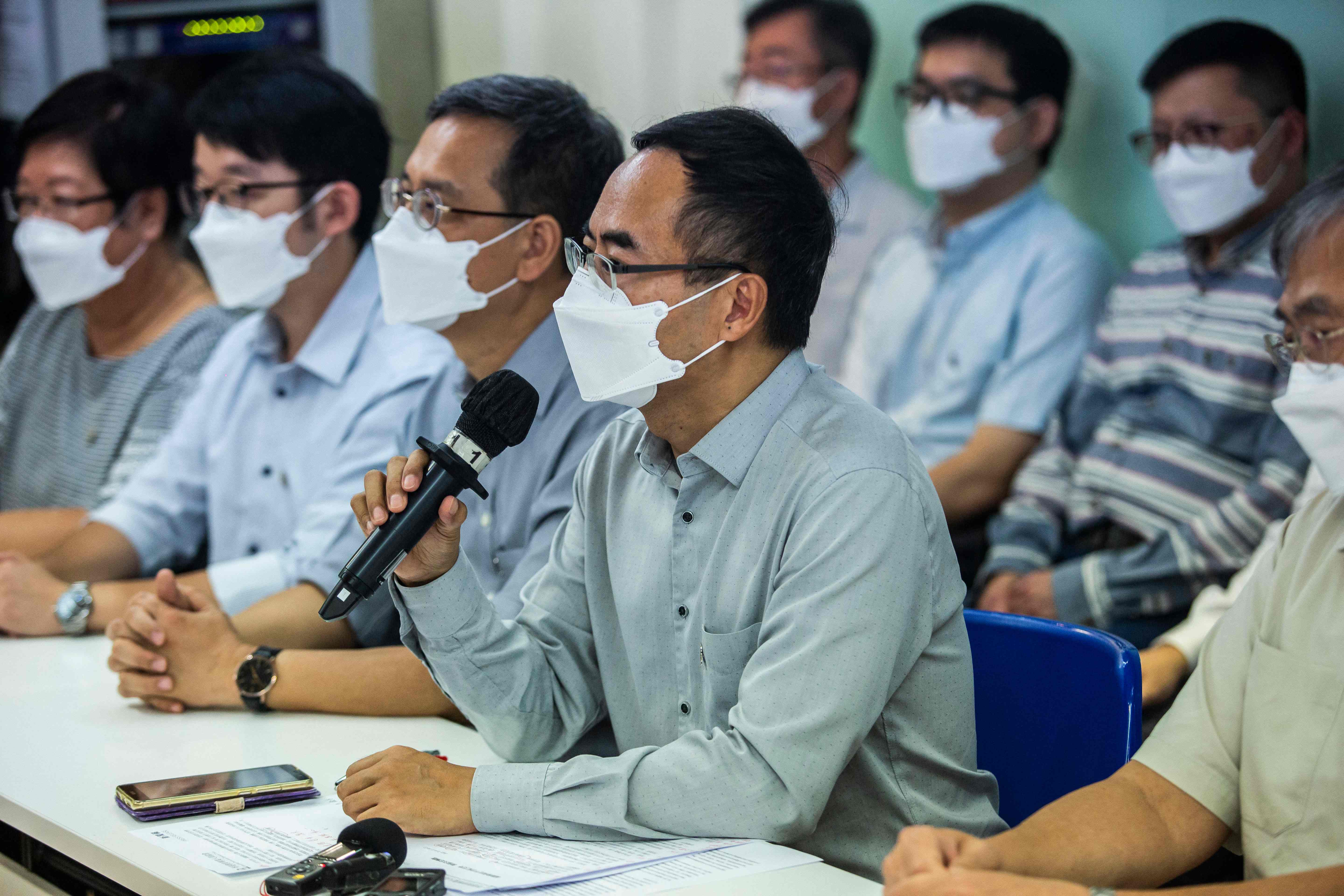 President of the Hong Kong Professional Teachers Union Fung Wai-wah (C) speaks at a press conference in Hong Kong on August announcing its decision to disband