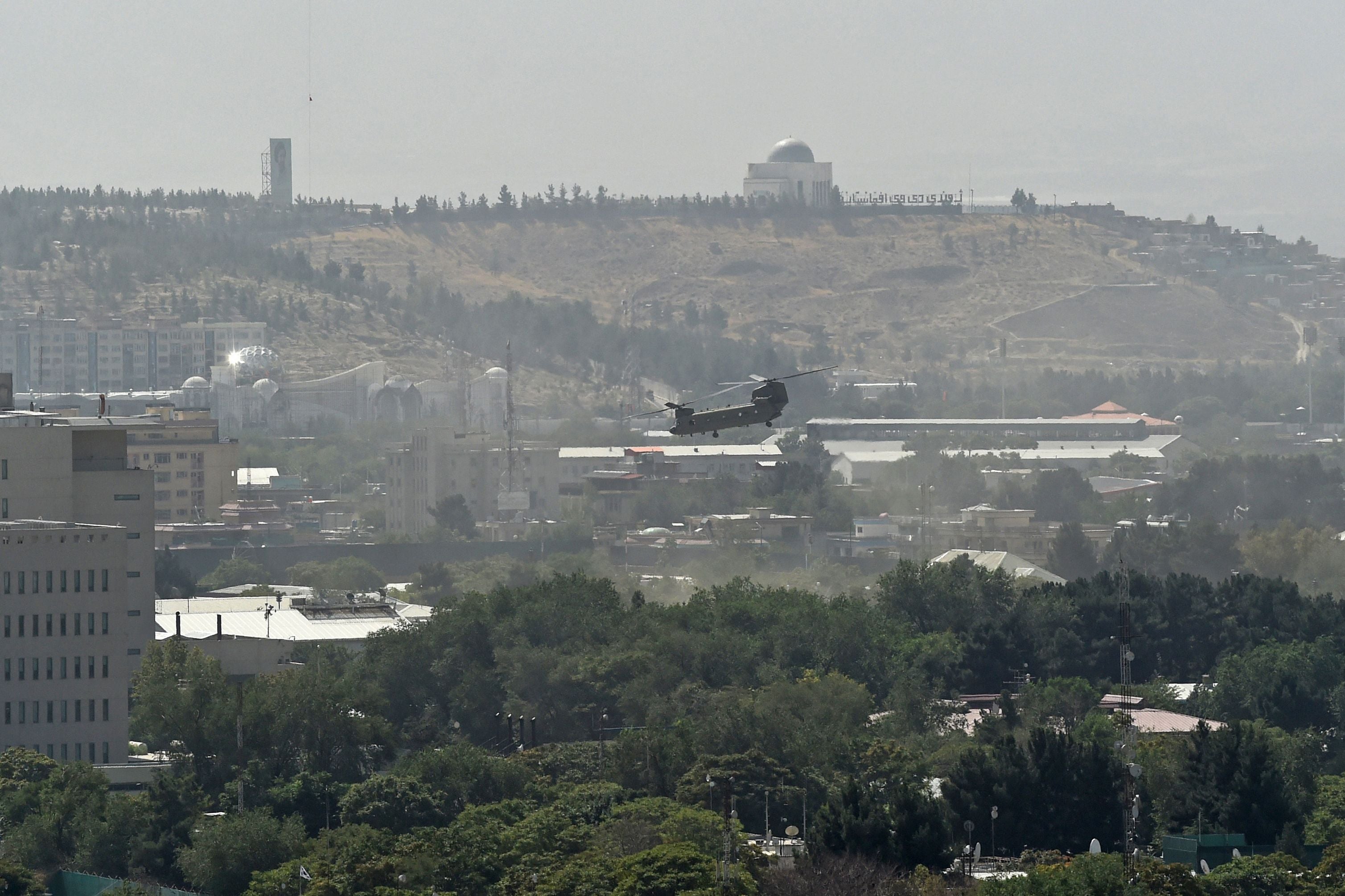 A US military helicopter is pictured flying above the US embassy in Kabul on 15 August 2021.