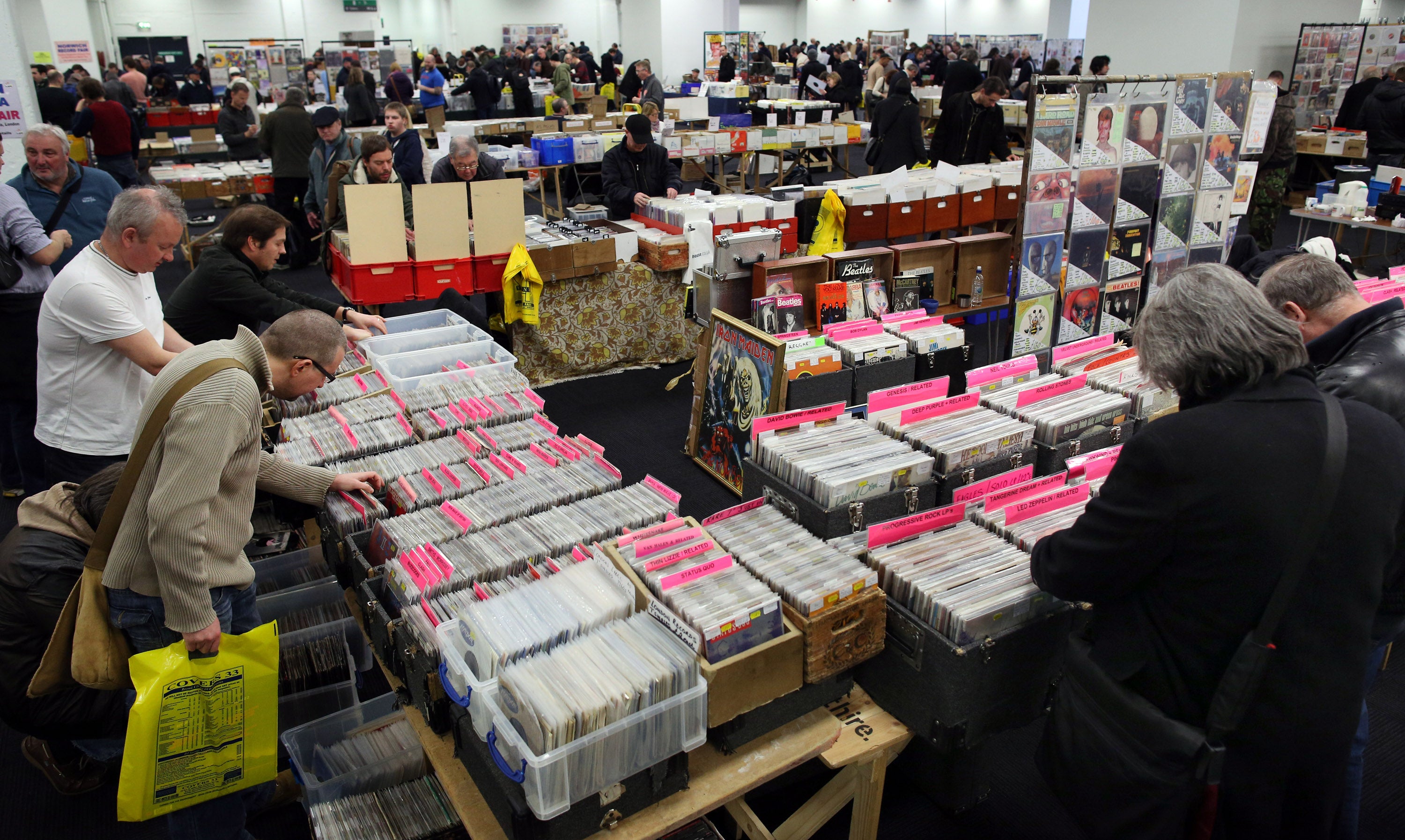 Collectors at a record fair at Olympia, January 2015. A large selection of rare and deleted vinyl records from punk, pop, reggae and R’n’B are offered for sale