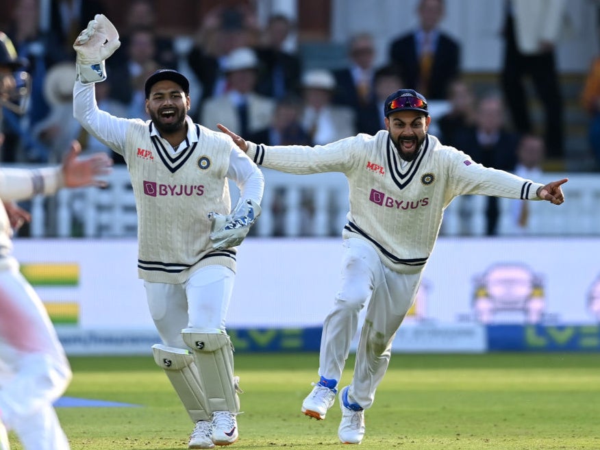Rishabh Pant and Virat Kohli of India celebrate the final wicket