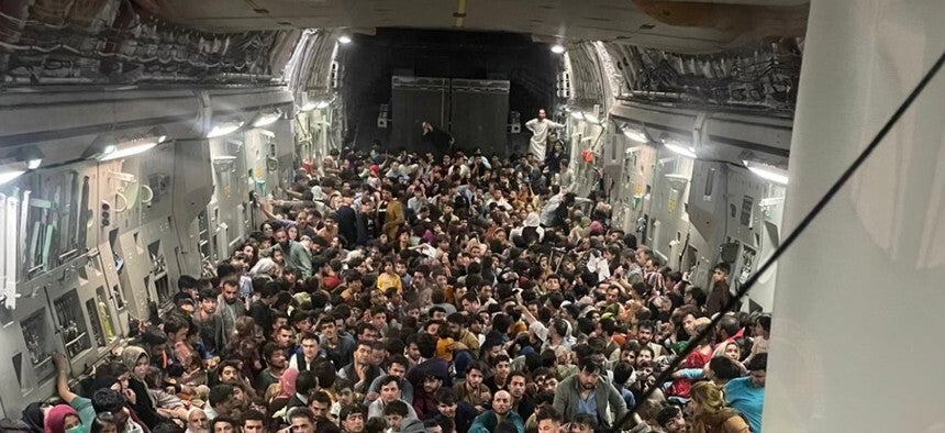 More than 600 Afghans squeeze onto a US evacuation flight out of Kabul on Sunday, 15 August, 2021