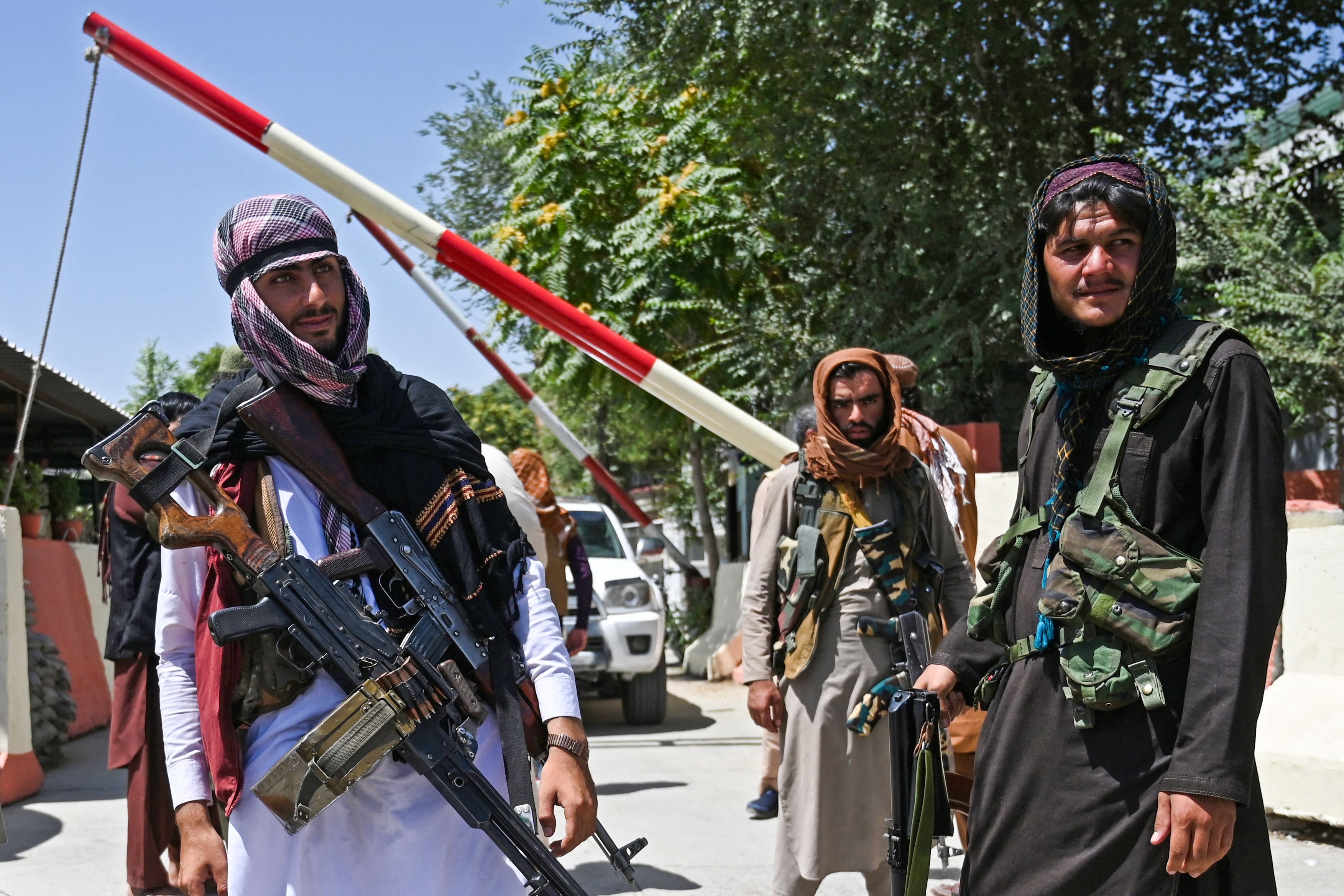 Taliban fighters stand guard along a roadside near the Zanbaq Square in Kabul on August 16, 2021, after a stunningly swift end to Afghanistan’s 20-year war