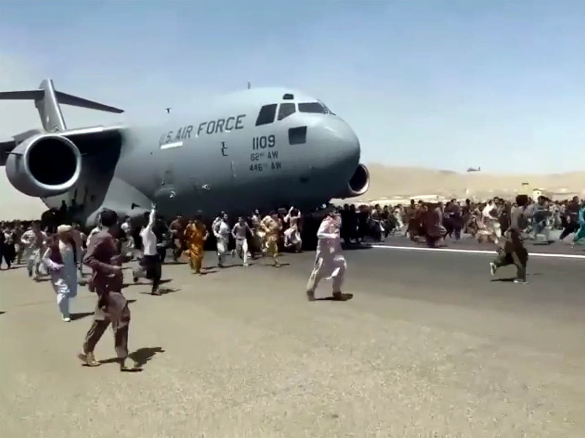 Human remains found in wheel well of US military plane after desperate Afghans cling to aircraft