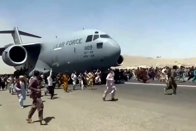 <p>Hundreds of people ran alongside a US Air Force C-17 transport plane as it moved down a runway at the international airport in Kabul</p>