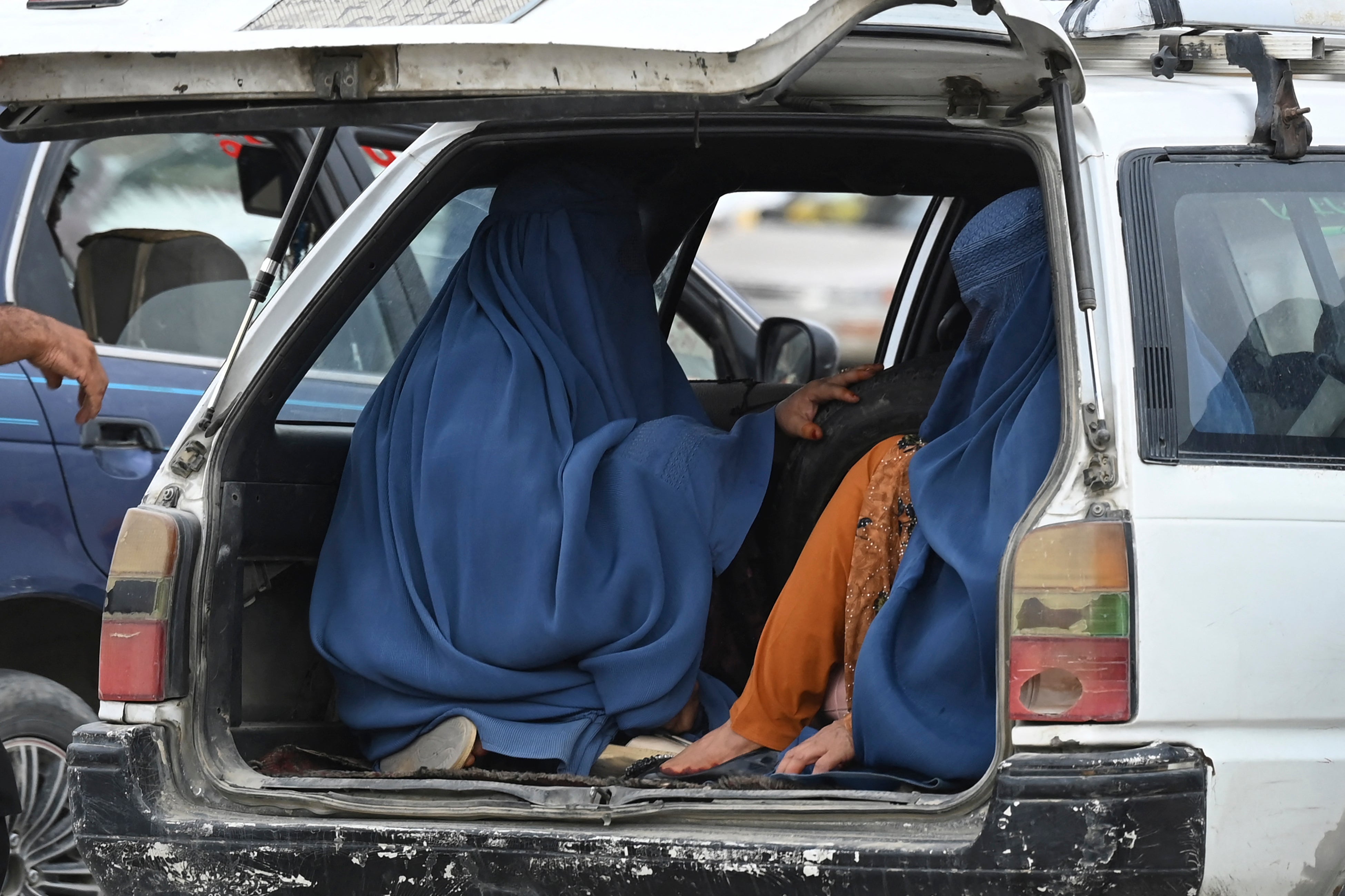 Women sitting in a cab in Afghan’s capital of Kabul at end of July