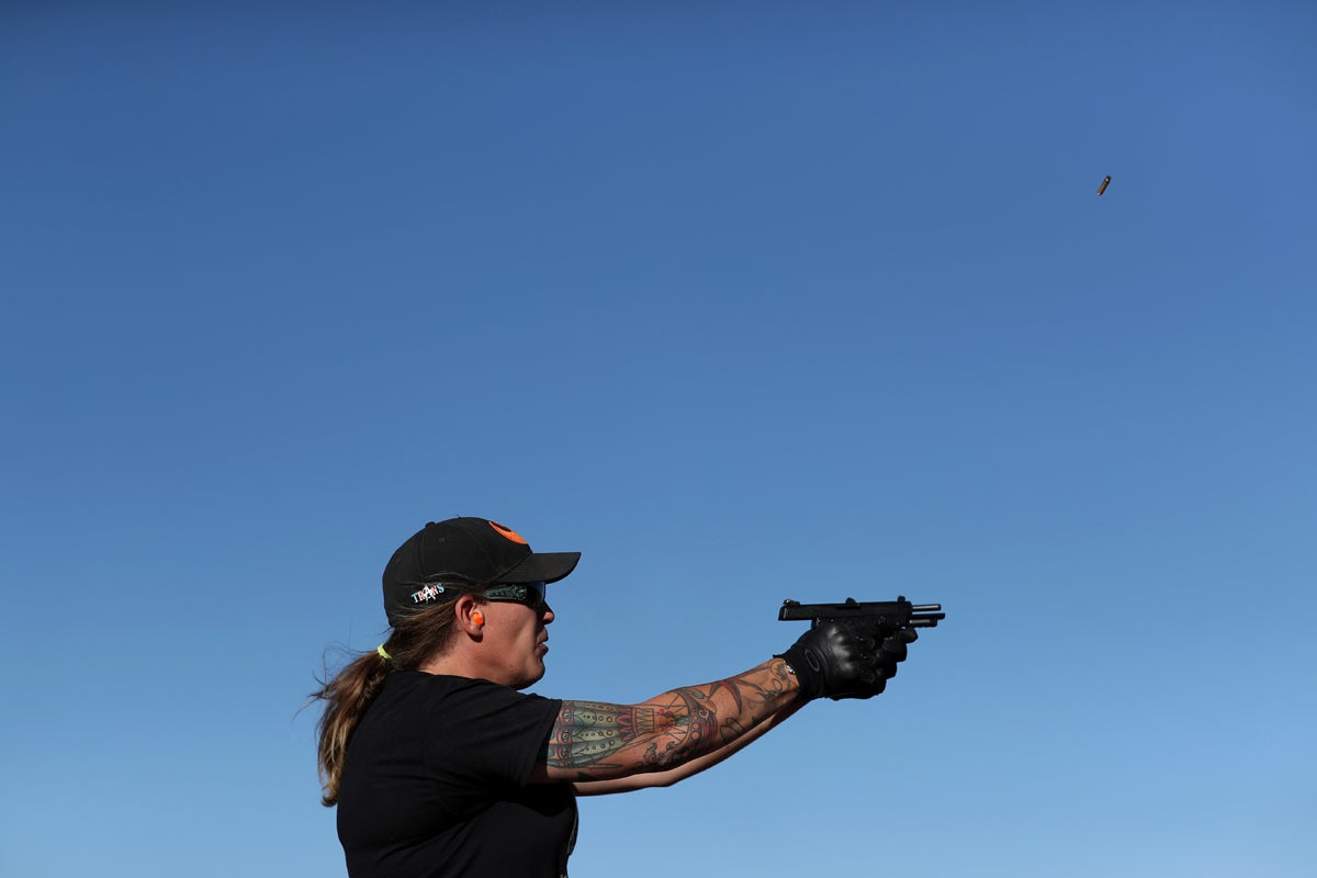 Penny Logue, 40, fires her pistol during target practice at a range