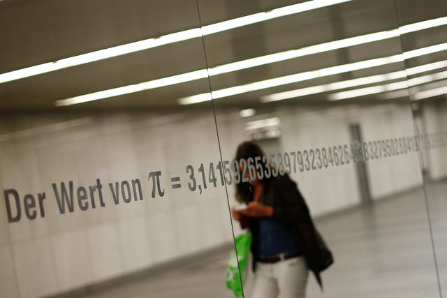 <p>A woman is reflected in a mirror with an inscription reading “The value of Pi” and its numbers in Vienna </p>