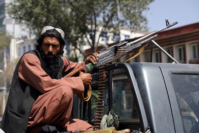 <p>A Taliban fighter outside the presidential palace in Kabul</p>