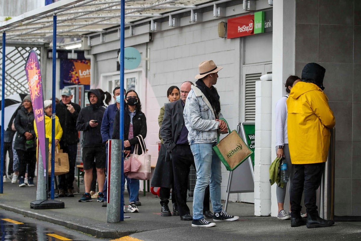 File: Shoppers lineup to enter a supermarket in Auckland, New Zealand