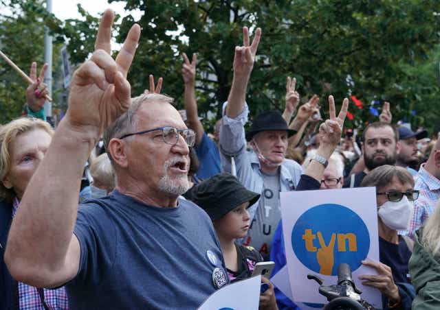 <p>Protesters show the victory sign as they hold up placards with the letters of Poland's main private TV network TVN, a US-owned broadcaster, as they demonstrate in defence of media freedom in Warsaw</p>