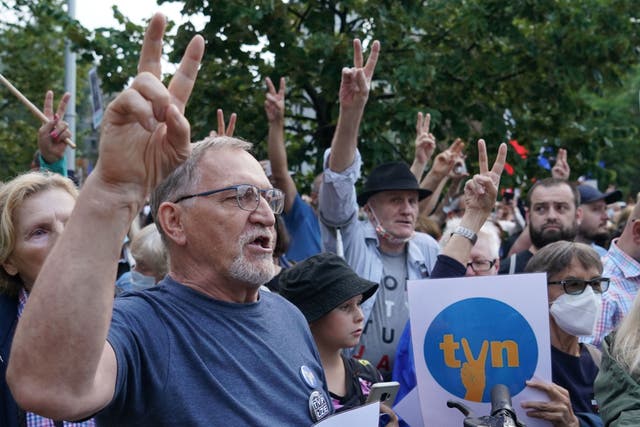 <p>Protesters show the victory sign as they hold up placards with the letters of Poland's main private TV network TVN, a US-owned broadcaster, as they demonstrate in defence of media freedom in Warsaw</p>