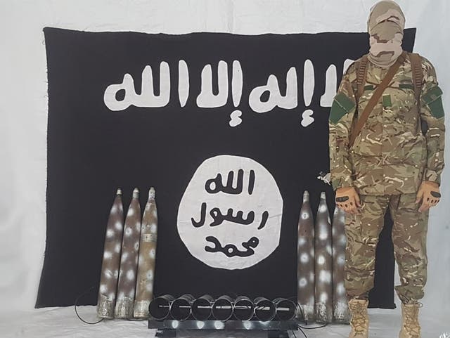 <p>A propaganda photograph of an Isis militant alongside rockets the group claimed were used to attack the presidential palace in Kabul on 20 July 2021</p>