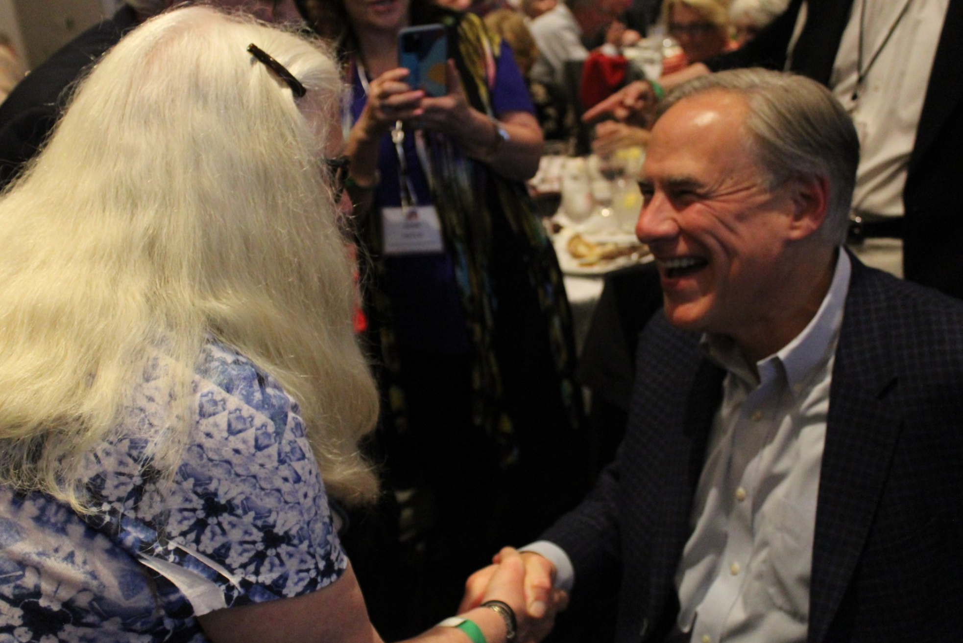 Mr Abbott’s greets wellwishers at a maskless Republican Party event in Collin County on Monday night