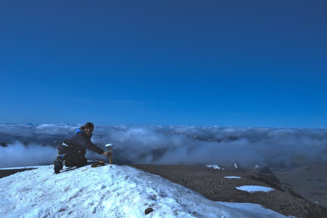 <p>Tarfala station manager Annika Granebeck measures the height at the top of Kebnekaise on 14 August 2021</p>