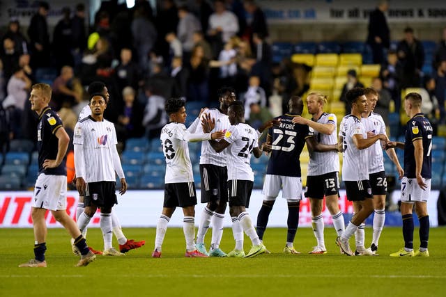 <p>Players hug at the end of the Sky Bet Championship match at The Den</p>