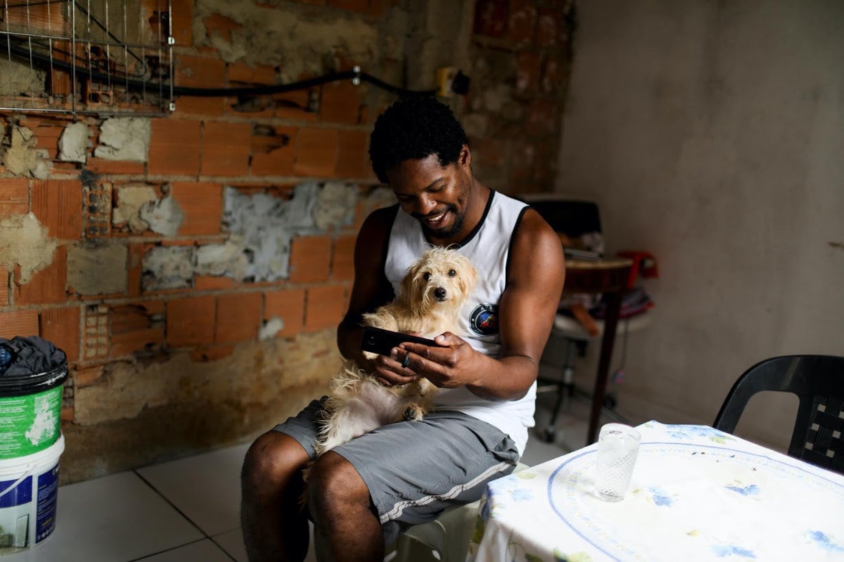 Felipe in his impoverished home with his dog