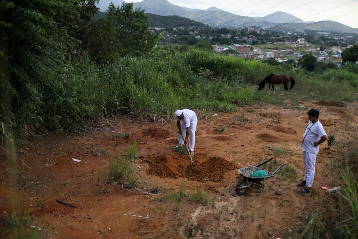 Felipe buries offerings during Umbanda ceremony in a terreiro