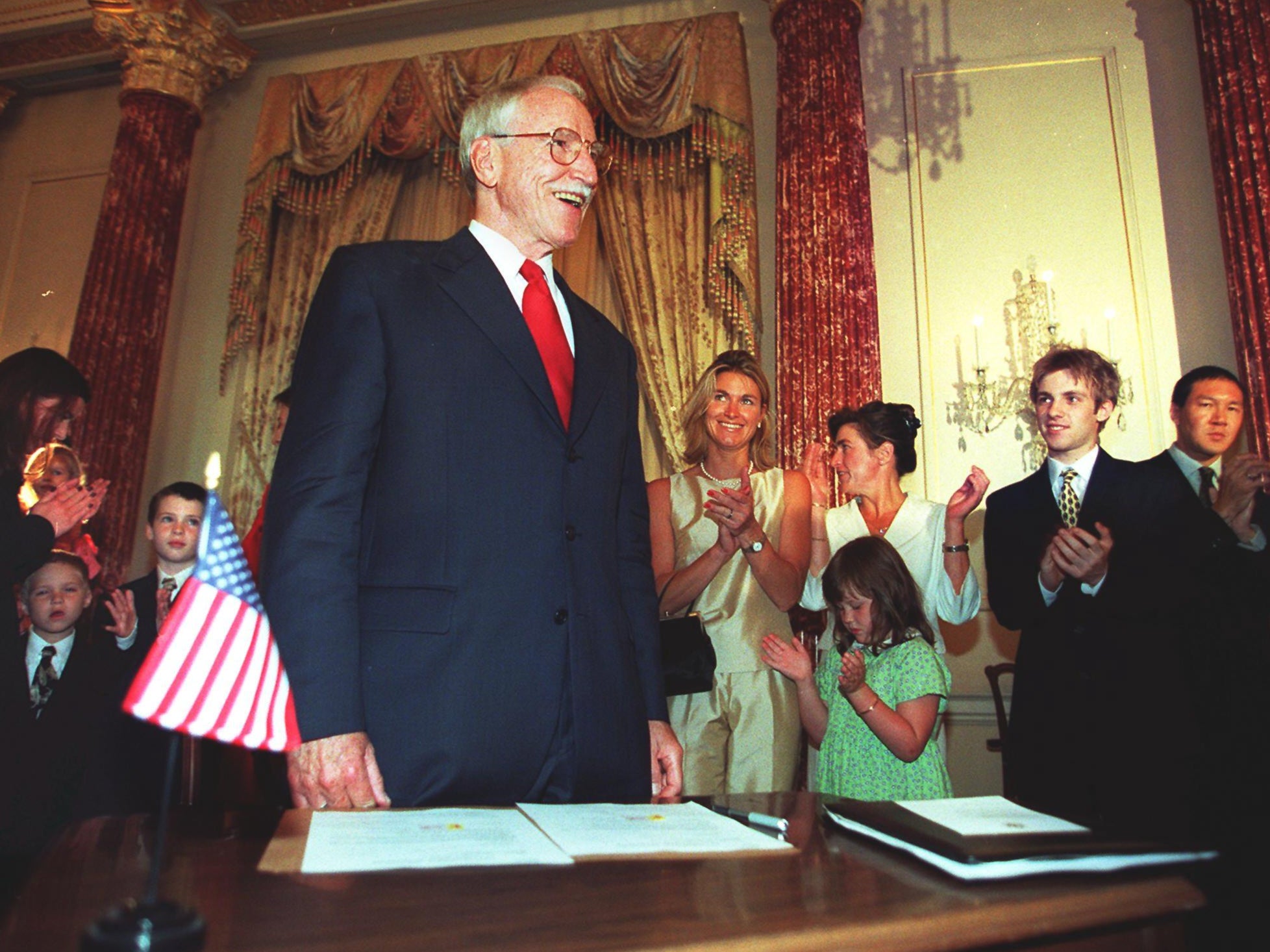 Family and friends applaud James Hormel after he is sworn in as US ambassador to Luxembourg at the State Department in Washington in 1999