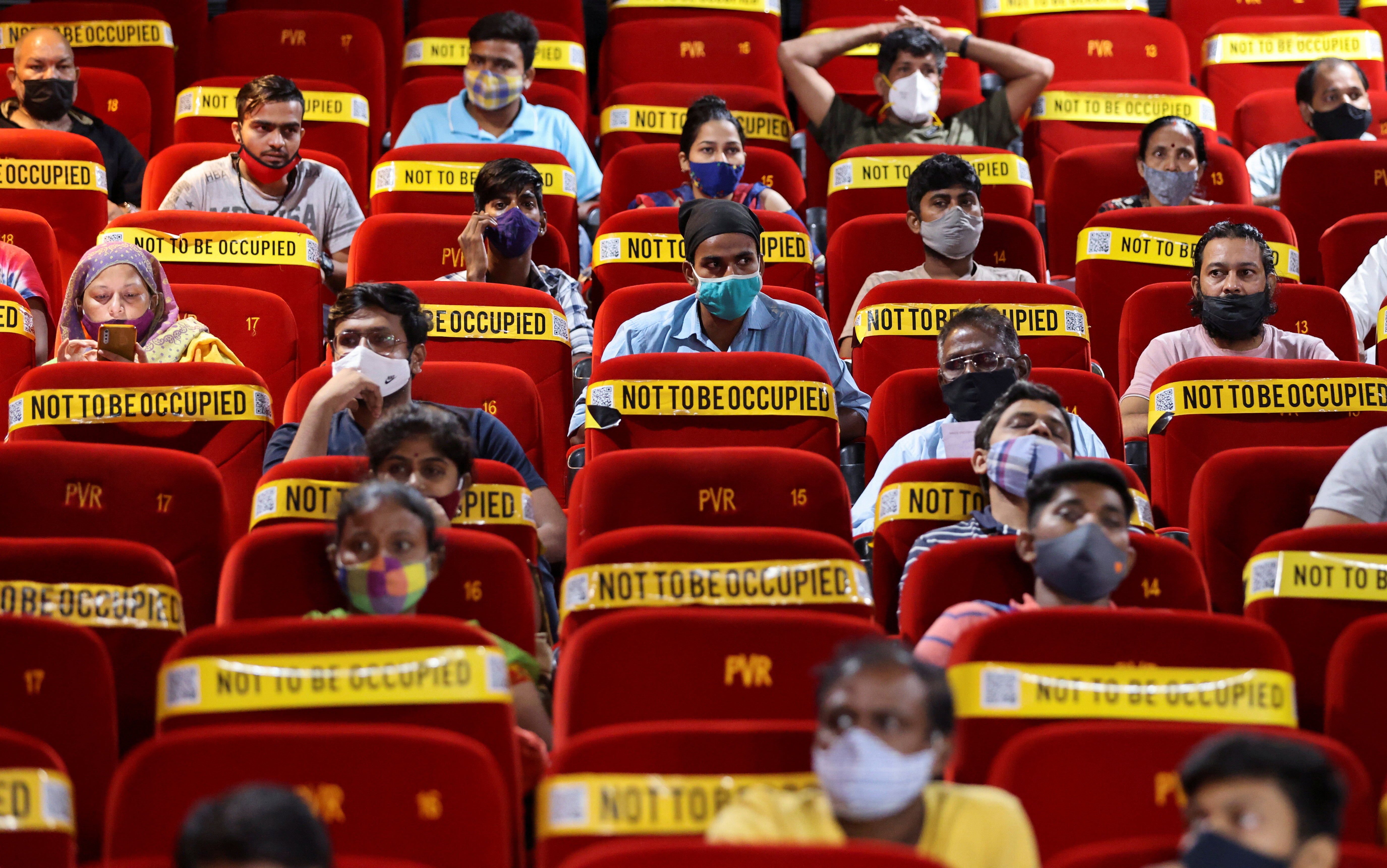People wait to receive a dose of Covishield, a vaccine manufactured by Serum Institute of India, at a cinema hall in India’s Mumbai city on 17 August 2021