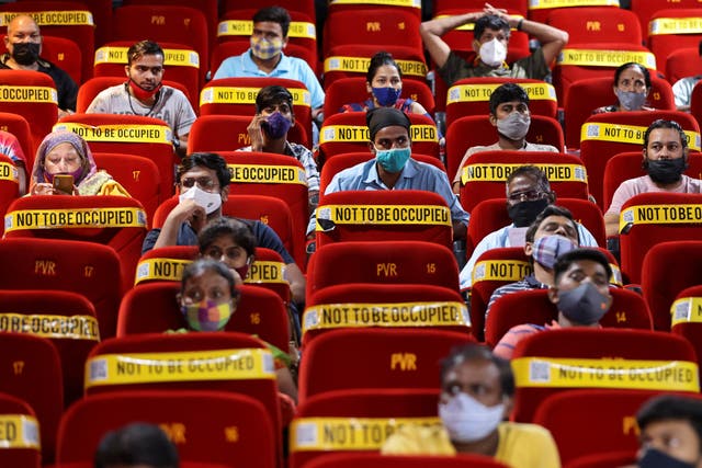 <p>People wait to receive a dose of Covishield, a vaccine manufactured by Serum Institute of India, at a cinema hall in India’s Mumbai city on 17 August 2021</p>
