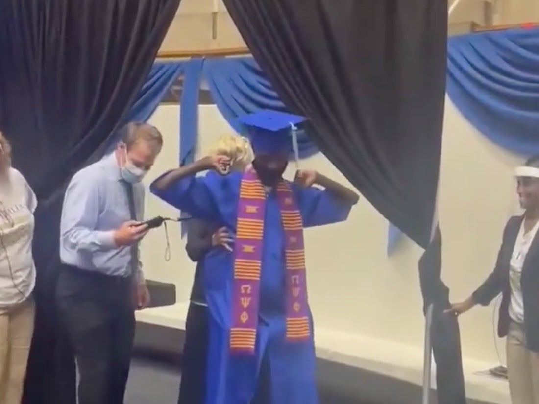 Paralysed former football player walks across stage to accept college diploma