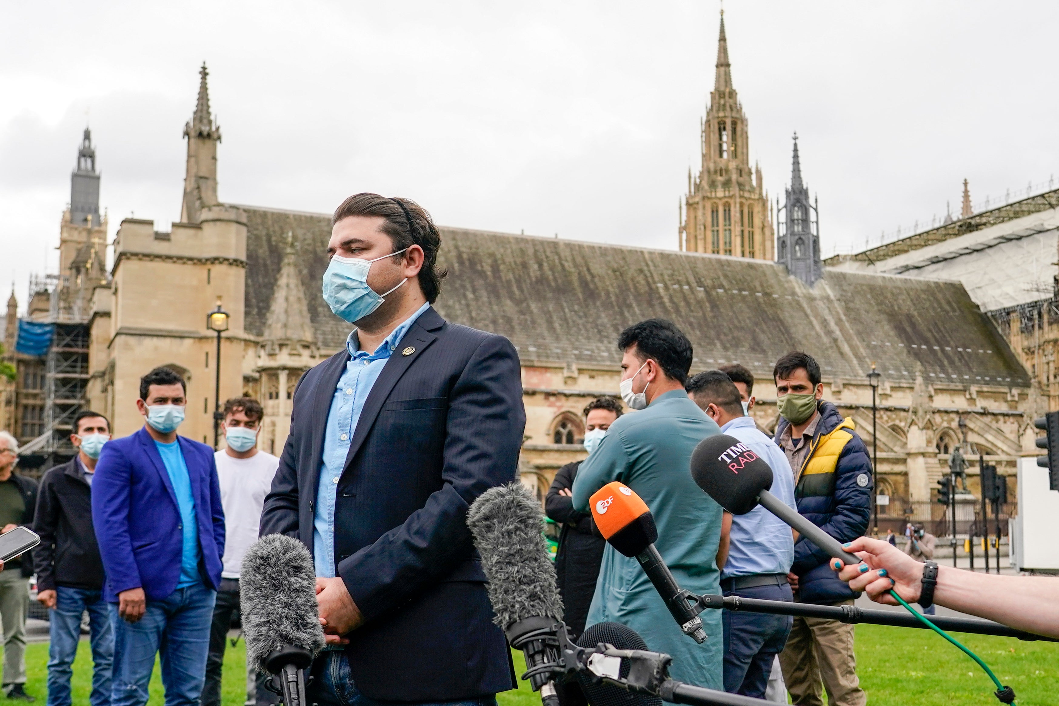 Former Afghan interpreter for the British Army, Razi, speaks with the media during a demonstration outside parliament in London on Wednesday