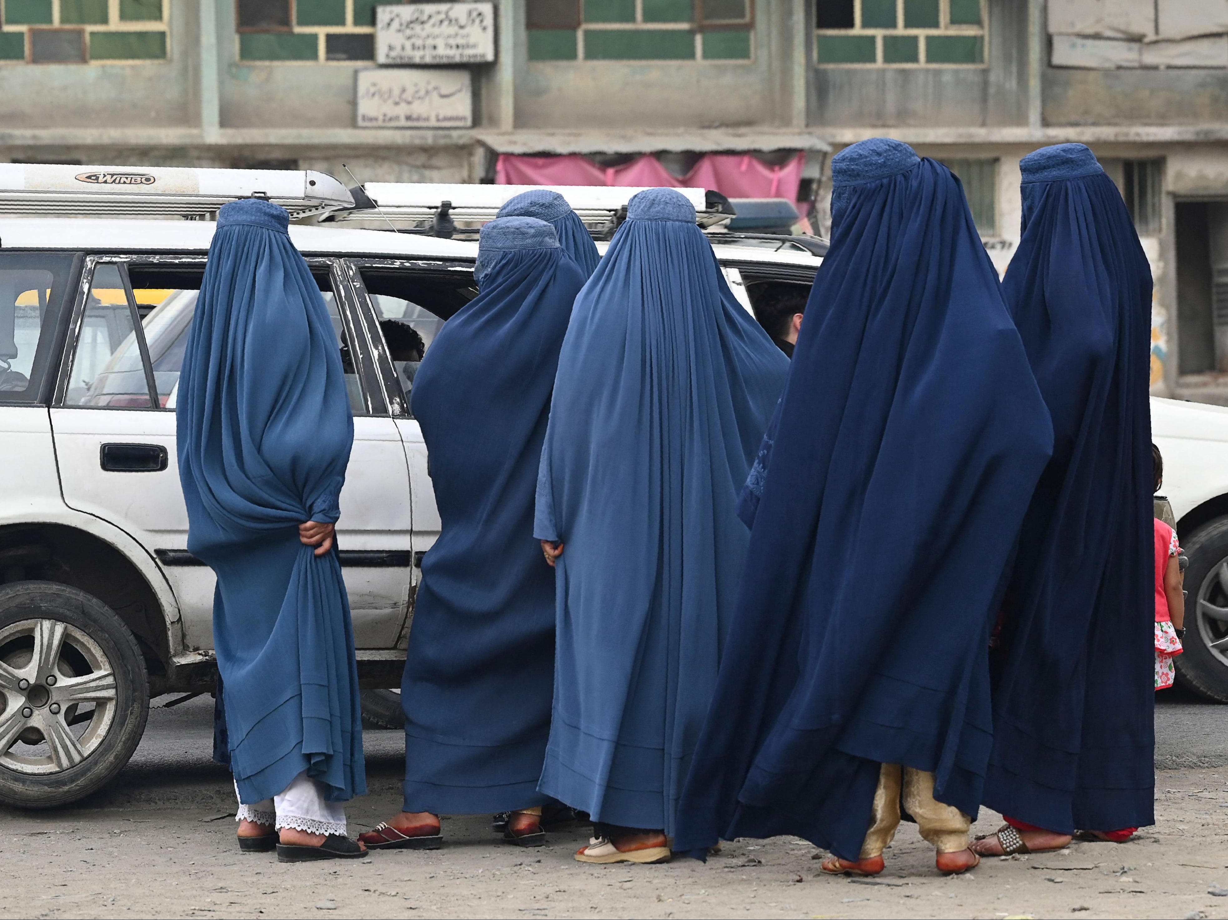 Women wearing a burqa are pictured in Kabul on 31 July