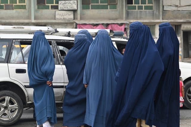 <p>Women wearing a burqa are pictured in Kabul on 31 July</p>