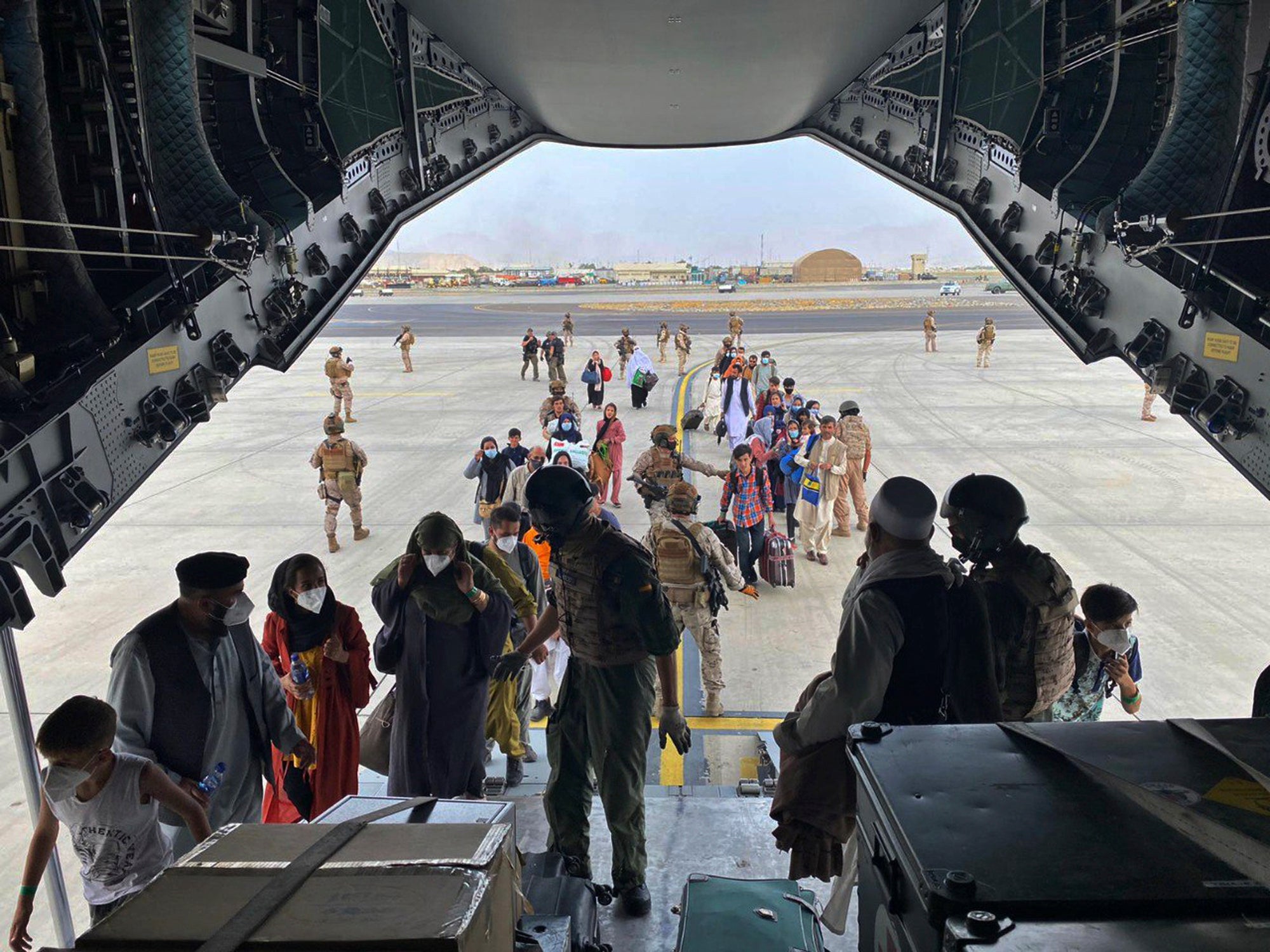 People board a Spanish airforce A400 plane as part of an evacuation plan at Kabul airport on Wednesday