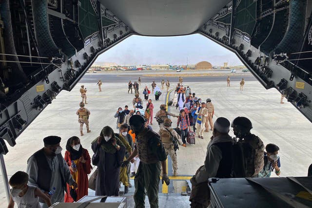 <p> People board a plane as part of an evacuation plan at Kabul airport</p>