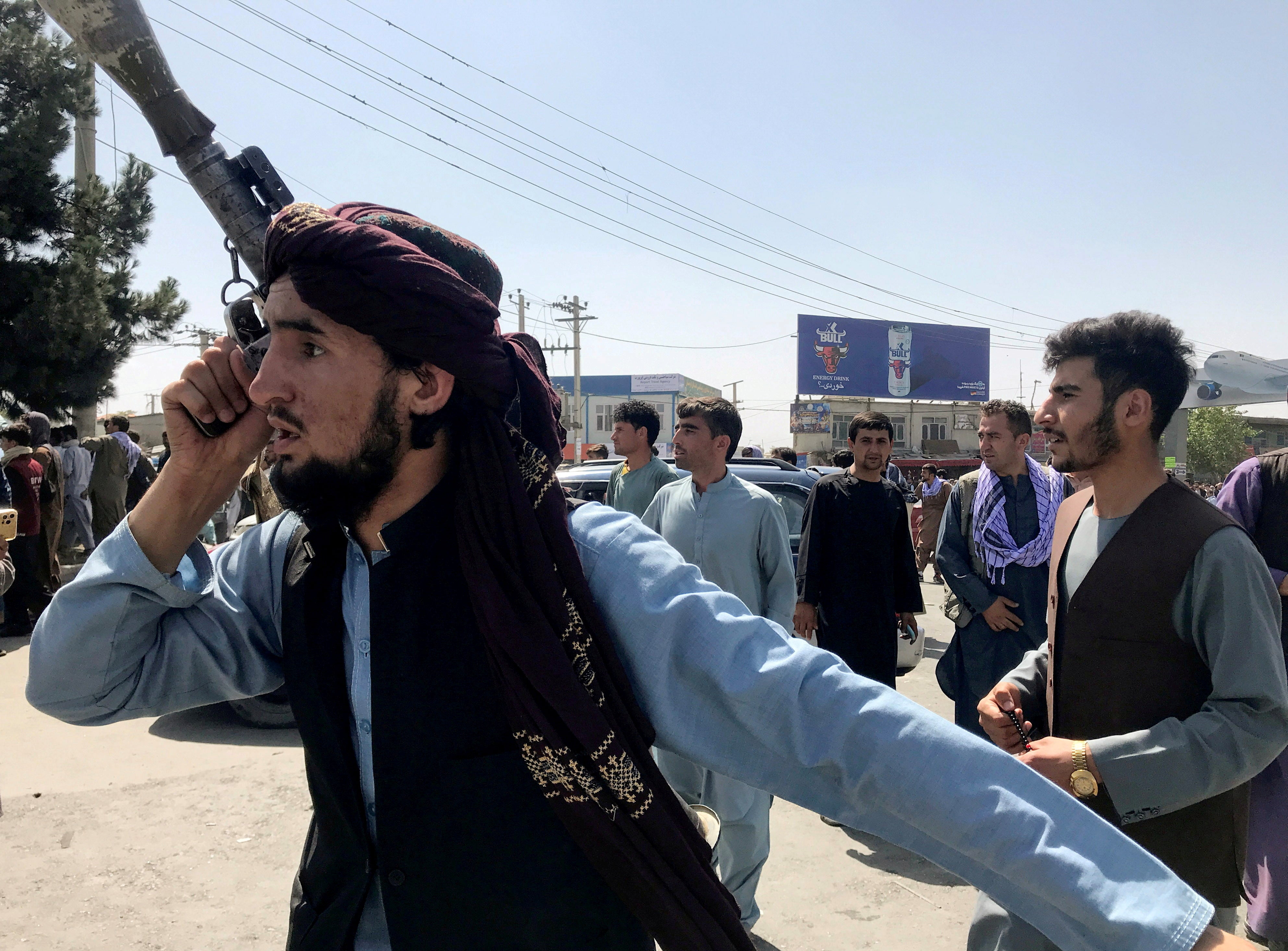 A member of Taliban forces inspects the area outside Hamid Karzai International Airport