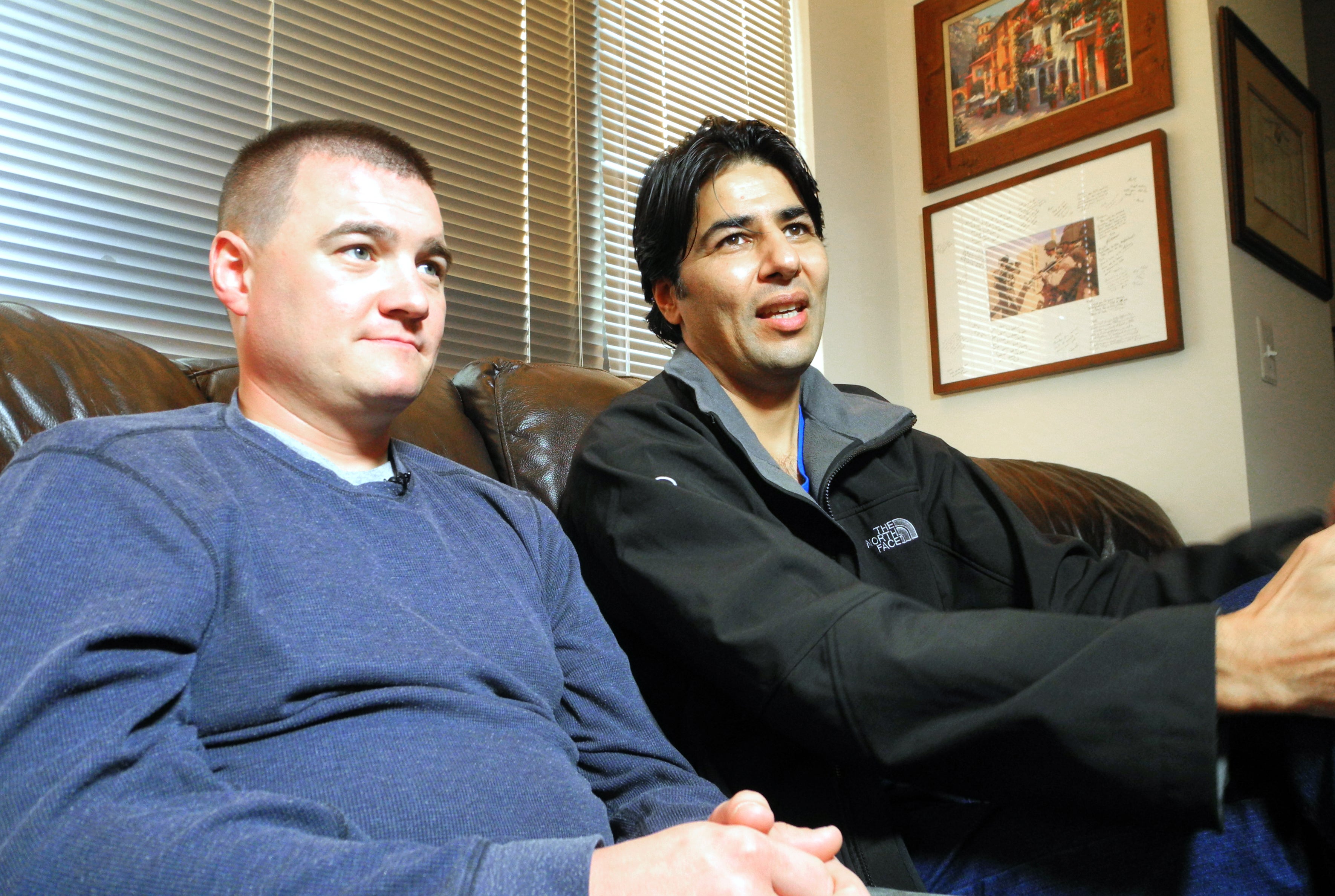 US Army Captain Matt Zeller (L) with translator Janis Shenwari, whom he credits for saving his life in a firefight in Afghanistan in November 2008, during an interview on November 21, 2013 in Arlington, Virginia.