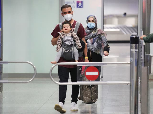 <p>A young family who are among the first evacuees to arrive from Kabul at Frankfurt International Airport on Saturday </p>